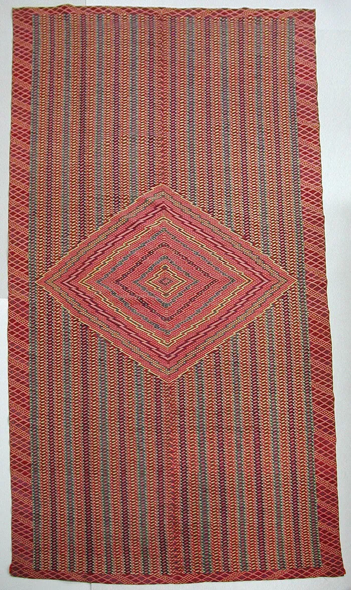 Tall rectangular Saltillo sarape woven in wool and cotton, with fine red and multicoloured stripes and zigzags around a large central diamond medallion