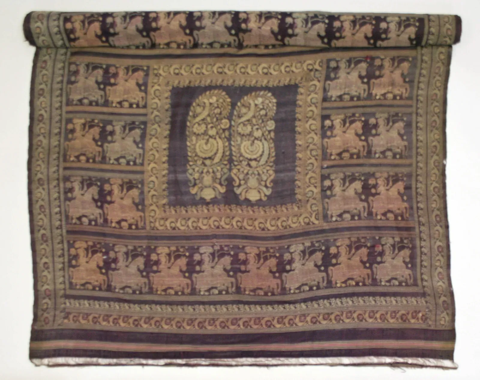 Partly rolled 18th-century silk sari in dark purple-brown with gold patterned borders, small repeating motifs and a central medallion